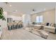 Open living space with luxury vinyl floors, a ceiling fan, and a large sectional with neutral paint and modern decor at 5321 Brayden Ct, Las Vegas, NV 89131