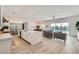 An open concept kitchen flows into the living room and features stainless steel appliances and stone countertops at 5321 Brayden Ct, Las Vegas, NV 89131