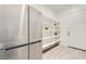 Spacious pantry features stainless steel refrigerator and open shelving, providing ample storage and easy access to food items at 5321 Brayden Ct, Las Vegas, NV 89131