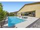 Inviting backyard features a sparkling pool, sun loungers, and an outdoor dining area, perfect for relaxation and entertainment at 5321 Brayden Ct, Las Vegas, NV 89131