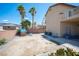Large backyard showcasing desert plants, small playhouse, a block wall, and mountain views at 54 Blue Fountain Ct, Henderson, NV 89012