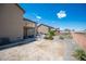 Spacious backyard with desert landscaping, a patio, and views of neighboring homes at 54 Blue Fountain Ct, Henderson, NV 89012