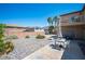 Spacious backyard with patio area, desert landscaping, and a balcony overlooking the space at 54 Blue Fountain Ct, Henderson, NV 89012