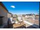This outdoor balcony features a seating area with views of the neighborhood and clear blue sky at 54 Blue Fountain Ct, Henderson, NV 89012