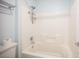 This clean bathroom showcases a shower-tub combo with white tiling, convenient shelves, and chrome fixtures at 54 Blue Fountain Ct, Henderson, NV 89012