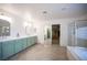 Bright bathroom with double sink vanity, decorative mirrors, walk-in shower and soaking tub at 54 Blue Fountain Ct, Henderson, NV 89012