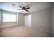Spacious bedroom with carpeted floors, ceiling fan and large window with natural light at 54 Blue Fountain Ct, Henderson, NV 89012