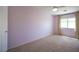Bright bedroom featuring carpet floors, neutral walls, a ceiling fan, and a large window at 54 Blue Fountain Ct, Henderson, NV 89012