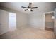 Open bedroom with carpeted floors, ceiling fan, walk-in closet and bright natural light at 54 Blue Fountain Ct, Henderson, NV 89012