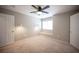 Comfortable bedroom featuring neutral carpet, ceiling fan, and window with convenient window seat at 54 Blue Fountain Ct, Henderson, NV 89012
