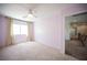 Light-filled bedroom with carpet, neutral walls, a ceiling fan, and a view towards the hallway at 54 Blue Fountain Ct, Henderson, NV 89012