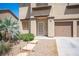 Inviting front entrance with decorative stone walkway, desert plants, and a secure storm door at 54 Blue Fountain Ct, Henderson, NV 89012