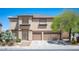 Two-story home featuring desert landscaping, a two-car garage, and a neutral color palette at 54 Blue Fountain Ct, Henderson, NV 89012