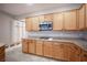 Kitchen with stainless steel microwave above cooktop and bright wood cabinets at 54 Blue Fountain Ct, Henderson, NV 89012