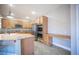 Modern kitchen boasts stainless steel appliances, an island, and an attached workspace at 54 Blue Fountain Ct, Henderson, NV 89012