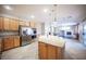 Open concept kitchen with island, stainless appliances, and view into the living area at 54 Blue Fountain Ct, Henderson, NV 89012