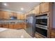Gourmet kitchen features stainless steel appliances, granite countertops, and custom cabinetry at 54 Blue Fountain Ct, Henderson, NV 89012