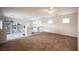 Spacious living room area offering natural light, neutral color palette, and ceiling fan at 54 Blue Fountain Ct, Henderson, NV 89012