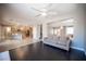 Open living room with dark floors, a ceiling fan, and a view into the adjacent kitchen and dining area at 54 Blue Fountain Ct, Henderson, NV 89012