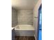 Bathroom featuring new bathtub with marble pattern ceramic tiles at 541 Indian Bluff St # 201, Las Vegas, NV 89145