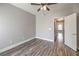 Bedroom with light gray walls, wood-look flooring, and a ceiling fan, provides a calm retreat at 541 Indian Bluff St # 201, Las Vegas, NV 89145