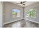 Serene bedroom with wood floors, two arched windows, and ample natural light at 541 Indian Bluff St # 201, Las Vegas, NV 89145