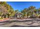 Inviting community entrance with a brick-paved road, lush landscaping, and decorative lighting at 541 Indian Bluff St # 201, Las Vegas, NV 89145