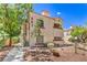 Inviting condo showcasing two-tone exterior, desert landscaping, and access stairs at 541 Indian Bluff St # 201, Las Vegas, NV 89145