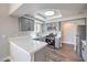 Well-lit kitchen boasts gray cabinets, quartz counters, stainless appliances, and wood floors at 541 Indian Bluff St # 201, Las Vegas, NV 89145