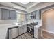 Updated kitchen featuring stainless steel appliances, grey cabinetry, and attractive white countertops at 541 Indian Bluff St # 201, Las Vegas, NV 89145