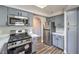 Renovated kitchen with stainless steel appliances and grey cabinets at 541 Indian Bluff St # 201, Las Vegas, NV 89145