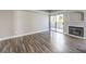 Open living room with wood floors, fireplace, and sliding doors to private balcony at 541 Indian Bluff St # 201, Las Vegas, NV 89145