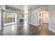 Bright living room featuring wood floors, fireplace, balcony, and arched doorways at 541 Indian Bluff St # 201, Las Vegas, NV 89145