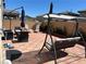 Cozy backyard patio featuring an outdoor swing, furniture, umbrella, and brick pavers at 5550 Jinan St, Las Vegas, NV 89148