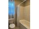 Bathroom featuring a white tub-shower with shower curtain and a white toilet at 5550 Jinan St, Las Vegas, NV 89148