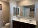 Spacious bathroom featuring double sinks, large mirror, and stone countertops at 5550 Jinan St, Las Vegas, NV 89148