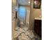 Bathroom with a white vanity, shower-tub combination, and decorative rugs at 5550 Jinan St, Las Vegas, NV 89148