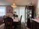 Formal dining room boasts elegant chandelier, and glass front china cabinet at 5550 Jinan St, Las Vegas, NV 89148