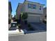 Two-story home with two-car garage, desert landscaping and green shuttered windows at 5550 Jinan St, Las Vegas, NV 89148