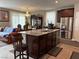 Open kitchen featuring a granite island, stainless steel appliances, and dark wood cabinetry at 5550 Jinan St, Las Vegas, NV 89148