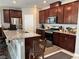 Open kitchen featuring granite countertops, stainless steel appliances, and dark cabinetry at 5550 Jinan St, Las Vegas, NV 89148