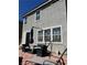 Back patio featuring red brick pavers, black patio furniture, and an umbrella at 5550 Jinan St, Las Vegas, NV 89148