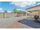 Spacious backyard featuring a covered patio and low-maintenance gravel landscaping, perfect for outdoor entertaining at 564 Lampshire Ln, Pahrump, NV 89060