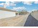 View of the backyard with low maintenance landscaping, block wall fencing, and covered patio at 564 Lampshire Ln, Pahrump, NV 89060