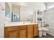 Bathroom featuring a large mirror, oak vanity, and a shower with glass doors at 564 Lampshire Ln, Pahrump, NV 89060