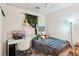 Cozy bedroom featuring a ceiling fan, a white desk, a window adorned with decorative greenery at 564 Lampshire Ln, Pahrump, NV 89060