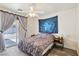 Bright bedroom featuring a ceiling fan, patio access, and a calming blue wall tapestry at 564 Lampshire Ln, Pahrump, NV 89060