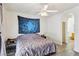 Cozy bedroom with a ceiling fan, unique wall art, and an arched doorway to the bathroom at 564 Lampshire Ln, Pahrump, NV 89060