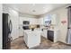 Bright kitchen features an island, stainless appliances, and white cabinets, creating a modern, functional space at 564 Lampshire Ln, Pahrump, NV 89060