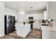 Well-lit kitchen features an island, stainless appliances, and white cabinets, creating a modern, functional space at 564 Lampshire Ln, Pahrump, NV 89060